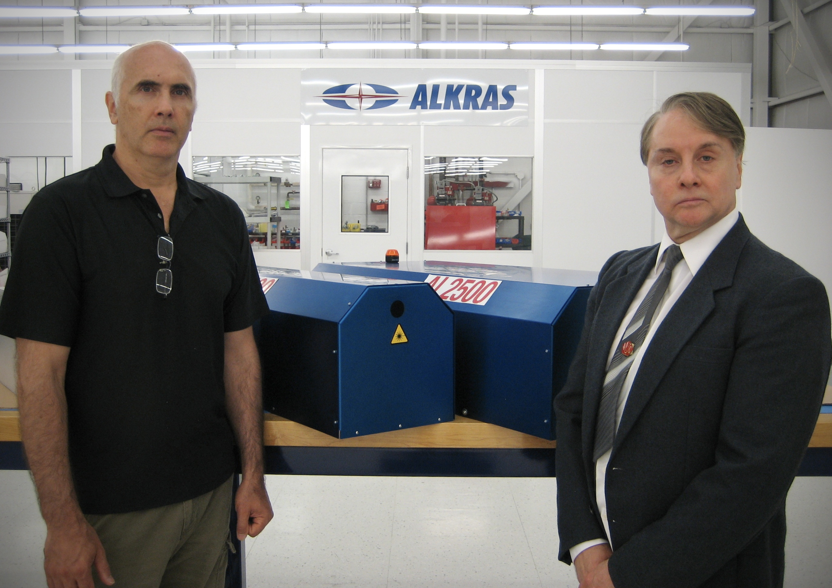 The founders of Alkras at the facility with an AL2500 laser system